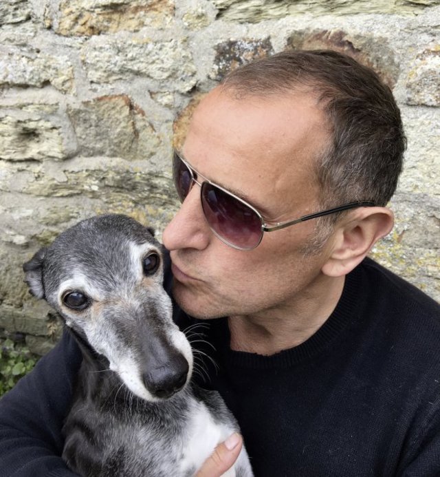 Mark Woods with his poor pooch Walnut. See SWNS story SWWALK; A dog lover has issued a heartfelt plea inviting people to join his pet for his LAST walk on his favourite beach before he is put down. Mark Woods has walked his 'best friend' Walnut for the past 18 years. But now Walnut's health has deteriorated due to his old age and he's started collapsing, so Mark has made the difficult decision to have him put to sleep. But before his life is ended, Mark wants to give him one final walk and has written an appeal on Facebook, asking for others to join him.